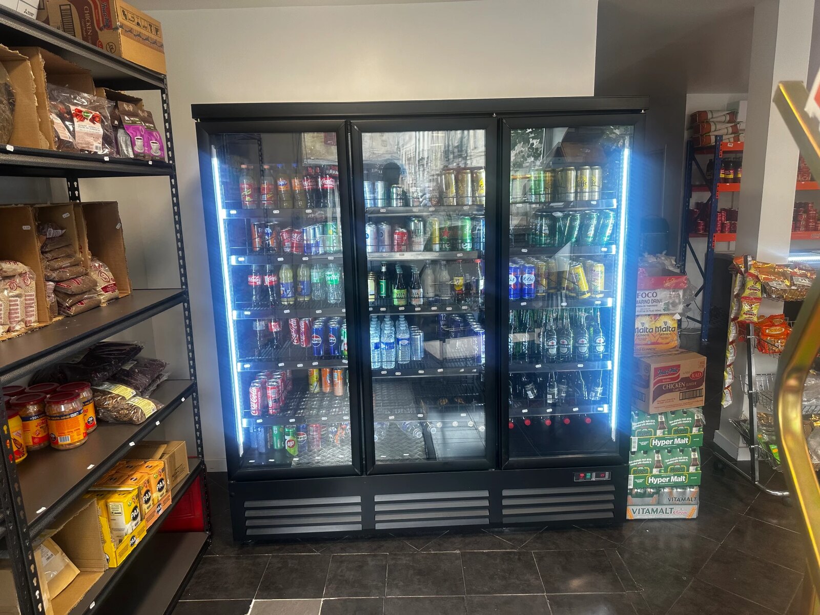 Fully stocked drinks fridge inside TEGA AFRO STORE